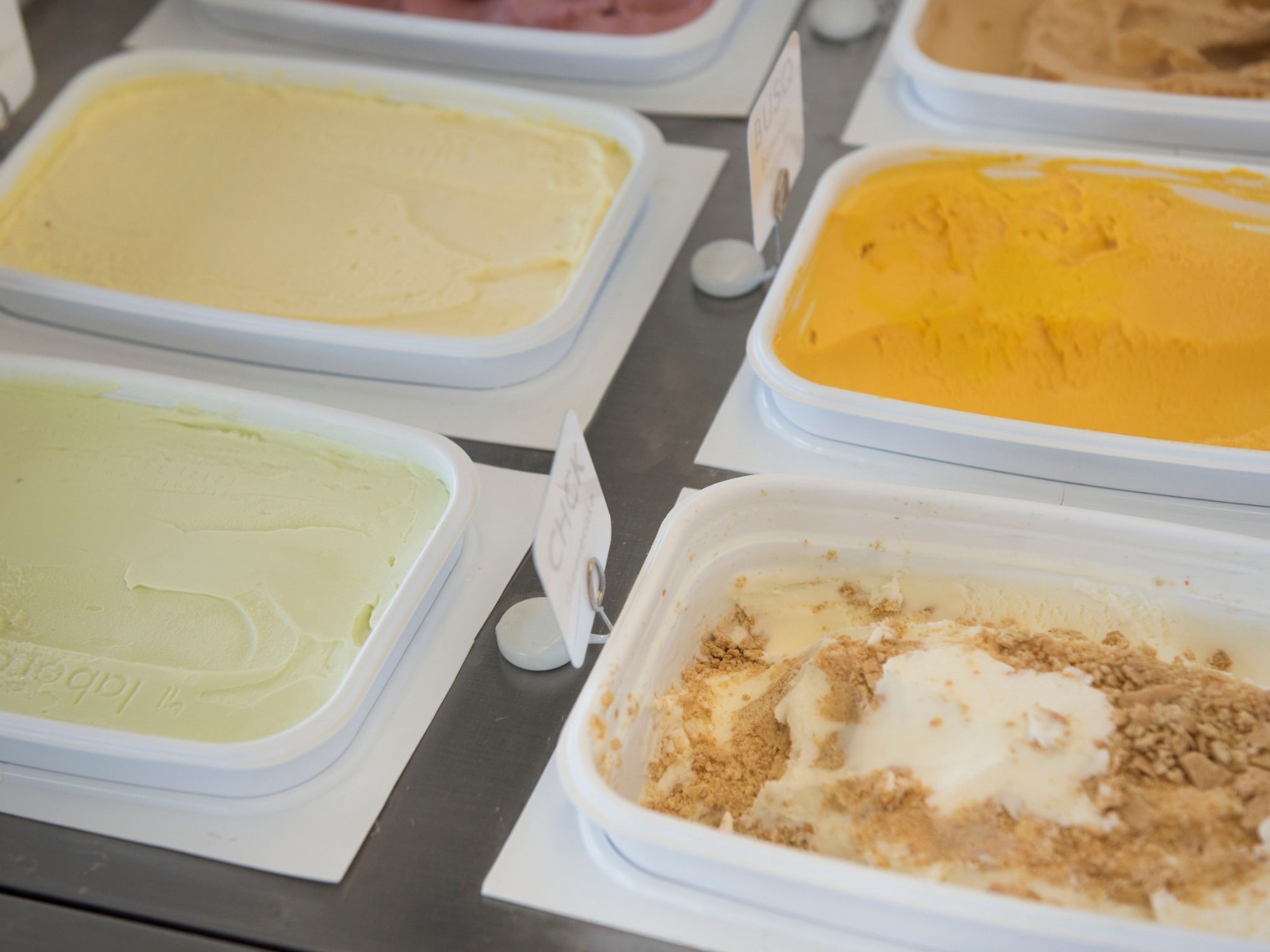 Seasonal gelato flavors in display case by il laboratorio del gelato