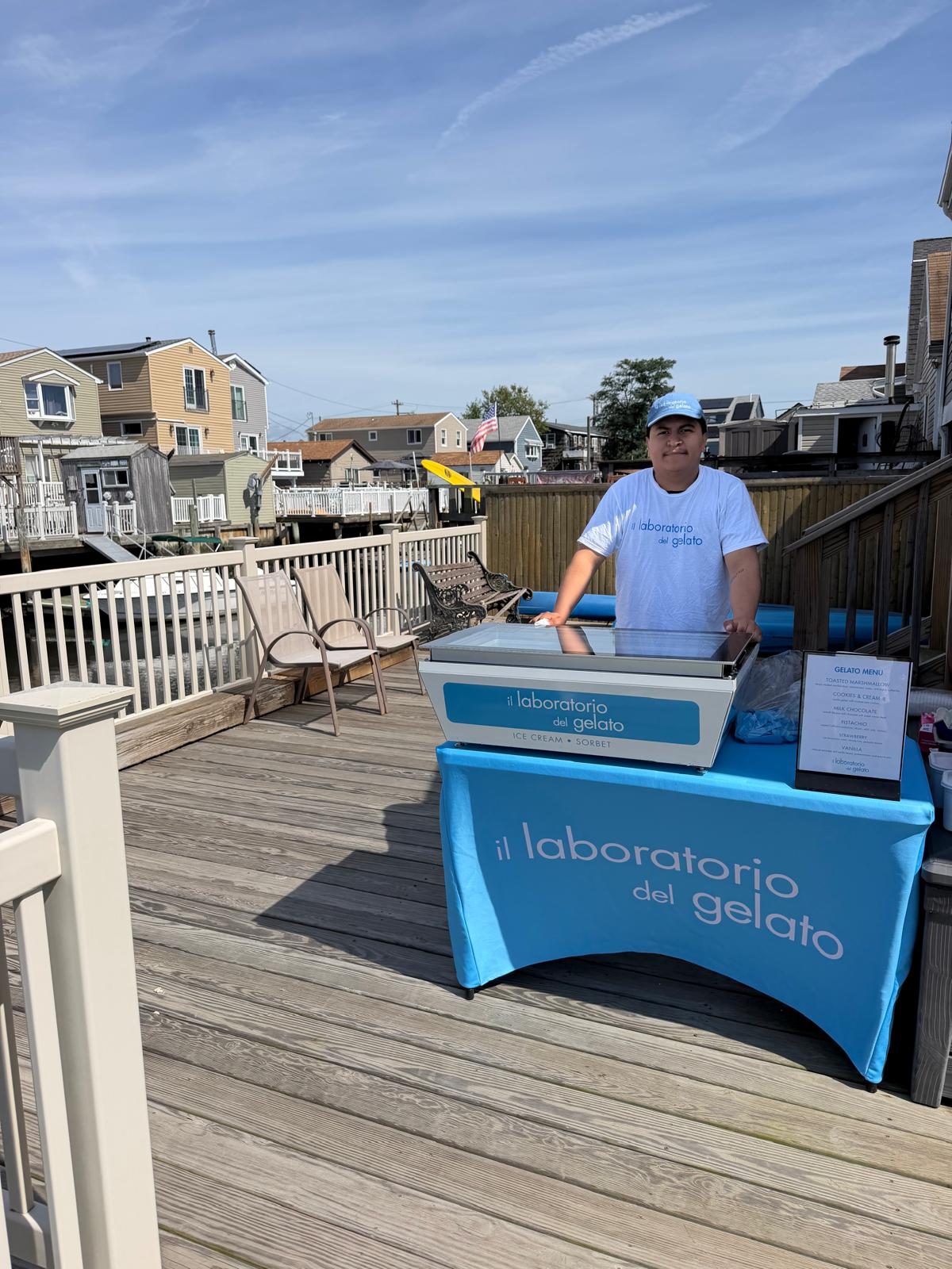 il laboratorio del gelato server behind a compact gelato station on a porch in Broad Channel, Queens