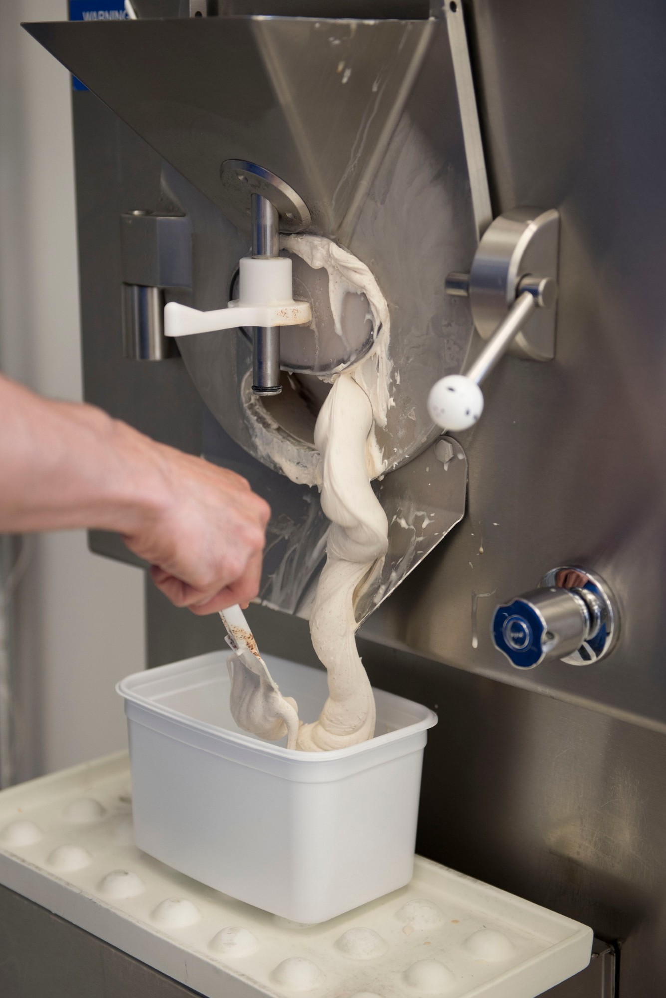 Freshly churned Italian-style gelato emerging dense and creamy from the machine